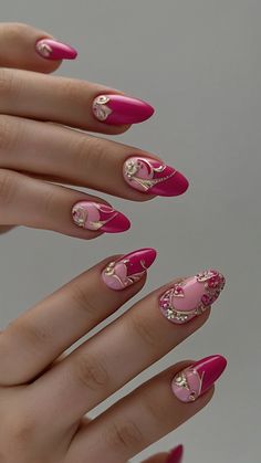 a woman's hand with pink and gold nail polishes on her nails, which are decorated with hearts