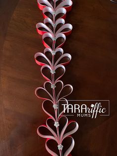 red and white paper hearts are arranged on a wooden table with the words marfa life mums