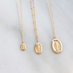 "Virgin Mary Medal Necklace & Gifts for Her The miraculous medal is perfect for yourself or as a special gift. Choose a small, medium or large oval medal and the chain of your choice! DETAILS -Small, medium or large 14kt gold filled Medal -A high quality delicate link or satellite chain -Charms and chain are 14kt gold filled - not plated LENGTH -Please select from the drop down selection. -The standard length is normally 18\". -Model is wearing a 16\"small and 20\" medium in Photos. ∙ EXTRA Gold Charm Necklace, Protection Necklace, Medallion Necklace, Miraculous Medal, Chain Anklet, Gold Medal, Religious Jewelry, Gold Filled Jewelry, Gold Charm