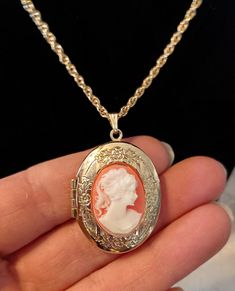 Vintage victorian style cameo necklace. Necklace is gold tone with resign cameo set on floral etched gold tone locket. Preowned Victorian Cameo Necklace, Cheap Vintage Necklace With Oval Pendant, Elegant Luxury Cameo Necklace, Rose Gold Locket Necklace For Formal Occasions, Elegant Rose Gold Cameo Necklace, Victorian Rose Gold Pendant Necklace, Victorian Rose Gold Medallion Necklace, Rose Gold Vintage Charm Necklace For Formal Occasions, Formal Rose Gold Necklace With Vintage Charm