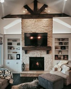 a living room filled with furniture and a flat screen tv mounted on the wall above a fireplace