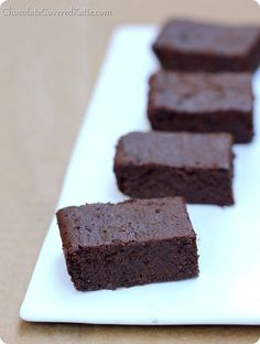 four pieces of brownie on a white plate