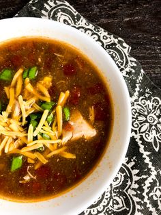 a white bowl filled with soup on top of a table