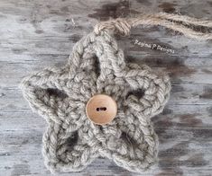 a crocheted star ornament with a wooden button