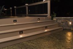 lighted steps leading up to an outdoor deck