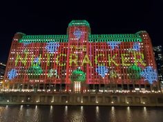 the building is lit up with colorful lights