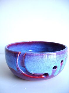 a blue and red bowl sitting on top of a table