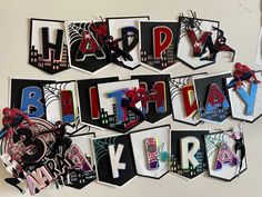 the happy birthday banner is hanging on the wall with spiderman and webs all over it