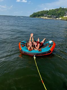 two people in an inflatable boat on the water