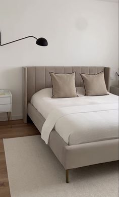 a bedroom with a large bed and white walls