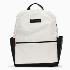 a white backpack with black trims on the front and side pockets, sitting against a white background