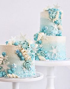 two blue and white cakes with snowflakes on them