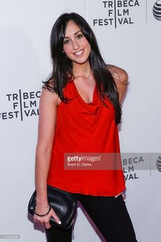 a woman in red shirt and black pants posing for the camera at tribe film festival