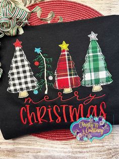 christmas tree applique on black fabric with merry lettering