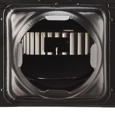 the inside of an empty black box with metal bars on it and a white background