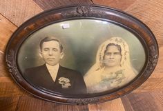 an old photo of a bride and groom on a wooden wall with wood paneling