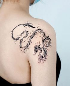 a woman with a dragon tattoo on her shoulder