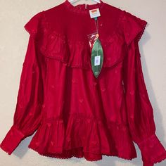 This Blouse Has Cute, Heart, Appliqu, Ruffles, And Lace To Make You Fall For Every Detail In The Coziest, Silhouette Easy Fit, High Smocked Neck, Long Sleeves With Heart-Shaped Button Cuffs, Open Back Detailing With Heart-Shaped Button Closure Fitted Long Sleeve Tops For Valentine's Day, Farm Rio Heart Dress, Bohemian Red Button-up Top, Bohemian V-neck Blouse With Ruffles, Bohemian Red Embroidered V-neck Top, Red Bohemian Embroidered V-neck Top, Ruffle Long Sleeve Blouse, Heart Blouse, Balloon Sleeve Blouse