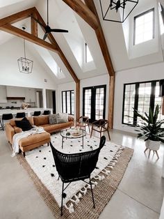 a living room filled with furniture and lots of windows