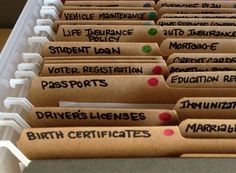 several file folders with labels on them are lined up in a row and labeled birth certificates