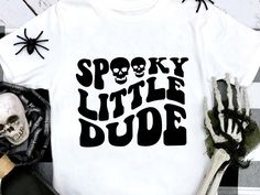 spooky little dude t - shirt with skeleton hands on the front and back