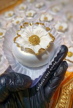 a close up of a cake on top of a table with gold trimmings