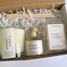 an open box containing candles, soaps and other items