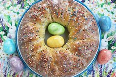 an image of a cake with two lemons in it on a plate surrounded by easter eggs