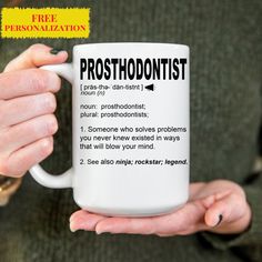 a person holding a coffee mug with the words prosthodontist on it