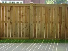 a wooden fence in front of a house