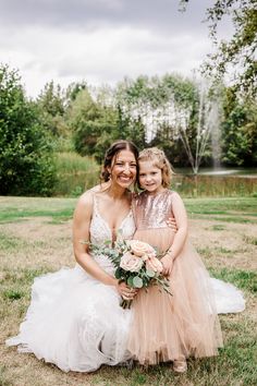 mother and daughter posing for the camera on their wedding day