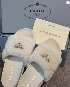 the prada slippers are white and have fur on them