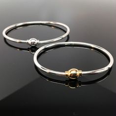 "This sterling silver Eternity Bangle is hinged to easily slip on the wrist. It features a threaded bead which completes the circle of eternity. The bangle can accommodate medium and large spacer beads, European style charm-beads, and traditional charms. Available in both sterling silver, and sterling silver with 14k gold vermeil. \"Sterling\" is inscribed on the inside of the band. Available in extra small, small, medium, and large. Extra small tends to fit a preschool girl or boy. Extra Small Hinged Sterling Silver Bangle Bracelet As Gift, Hinged Sterling Silver Bangle Bracelet For Gift, Sterling Silver Hinged Bracelet For Gift, Adjustable Bangle Bracelets With Box Clasp, Adjustable Bangle Bracelet With Box Clasp, Sterling Silver Bracelets With Box Clasp, Hammered Metal Jewelry, Braclets Gold, Modern Bracelet