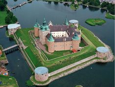 an aerial view of a castle in the middle of water