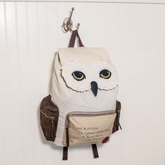 an owl backpack hanging on the wall