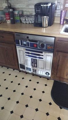 a star wars themed oven in the middle of a kitchen countertop with black and white tiles