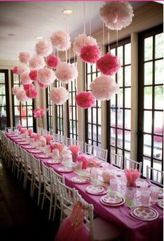 a long table with pink and white decorations