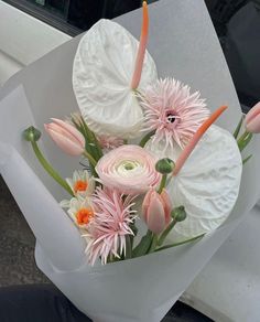 a bouquet of white and pink flowers in a vase