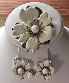 "Vintage Sarah Coventry white and silver flower brooch and earrings.  The 2 inch flower brooch has white enamel and silver petals.  The matching clip on earrings have the same design completing the \"Summer Magic\" set.  All jewelry sent in a gift box. Check out more vintage Sarah Coventry  https://www.Etsy.com/shop/Historicallyhers" Formal White Clip-on Flower Earrings, White Flower Clip-on Earrings, White Clip-on Flower Earrings, White Flower Clip-on Earrings For Formal Events, White Enamel Brooch Jewelry, Elegant Silver Enamel Flower Earrings, White Flower-shaped Clip-on Earrings For Formal Occasions, White Flower-shaped Clip-on Earrings For Formal Events, White Flower Shaped Clip-on Earrings For Formal Events