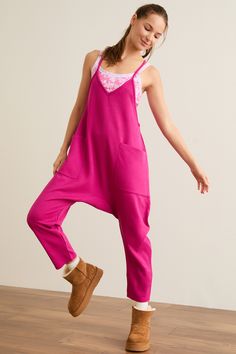 Instantly elevate your athleisure looks with this jumpsuit, perfect for all seasons. Guaranteed to be a new go-to, this one-piece features a slouchy style with front pockets, a v-neckline, and cozy relaxed fit. Pair with your favorite sports bra or strappy tank for the coolest fit for all your travel days. Casual V-neck Jumpsuit With Relaxed Fit, Spring Athleisure Overalls Jumpsuit, Comfortable Relaxed Fit Overalls, Sporty Relaxed Fit Jumpsuits And Rompers For Loungewear, Relaxed Fit Jumpsuits And Rompers For Loungewear, Relaxed Fit Overalls Jumpsuit For Loungewear, Spring Athleisure Jumpsuits And Rompers For Lounging, Relaxed Fit Overalls For Loungewear, Relaxed Fit Casual Overalls For Loungewear