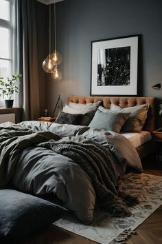 a large bed sitting in a bedroom next to a window with two lamps hanging above it