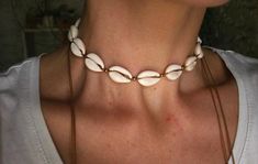 Cowrie shell choker necklace, made by hand using tan color waxed cord.Can be worn in different lengths to fit your each time needs. Adjustable closure that tightens and looses with ease for the perfect fit. Just pull the endings and the necklace will close on the length you wish.Detailed with lead and nickel free brass beads, There are two smaller shells as a decorative touch, at the endings of the necklace. All placed carefully and secure for a stable result on the cord.A piece you can match wi Beachy Vacation Choker Jewelry, Bohemian Strand Choker For Summer, White Bohemian Choker For Beach, Bohemian Cowrie Shell Choker For Summer, Bohemian Shell Choker As Gift, Bohemian Cowrie Shell Choker, Bohemian Shell Strand Choker, Bohemian Shell Choker Necklace For Vacation, Bohemian Shell-shaped Choker For Beach