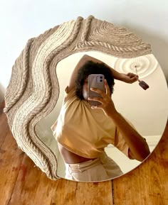 a woman taking a selfie in front of a mirror