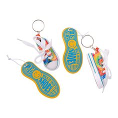 two key chains with shoes on them and one has a shoe in the shape of a sneaker