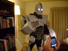 a person taking a photo of a robot with a cell phone