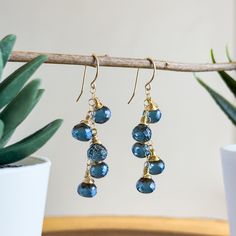 These mesmerizing handmade gemstone earrings are handcrafted with love and attention to detail using stunning London Blue Quartz gemstone onion-shaped briolettes. Each Quartz briolette is intricately wire wrapped using 14k gold-filled wire. Click here to see our full line of handmade gemstone earrings: https://www.etsy.com/shop/wanderlustdesigntx/?section_id=36954387 Dangling gracefully from a central 14k gold-filled chain, these earrings are perfectly dainty with an essence of classic elegance, Gemstone Dangle Cluster Earrings As Gift, Gift Dangle Linear Earrings With Lever Back, Gift Linear Dangle Earrings With Lever Back, Blue Cluster Drop Earrings As Gift, Blue Drop Cluster Earrings For Gift, Handmade Blue Cluster Earrings For Gift, Drop Cluster Earrings With Ear Wire As Gift, Gift Crystal Briolette Earrings With Ear Wire, Briolette Crystal Earrings With Ear Wire For Gift