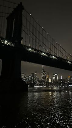 the brooklyn bridge is lit up at night