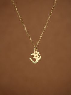 "Gold ohm necklace, yoga necklace, pranava, omkara, zen necklace, silver ohm necklace A gold vermeil ohm symbol hangs from a 16 inch 14k gold vermeil chain. Please feel free to select a different length chain if you prefer! Ohm Measurement: 12mm Ohm is a holy meditation symbol of Hinduism, Buddhism, and Jainism with a profusion of esoteric and exoteric meanings. In modern usage Om means the Word, the \"parnava,\" the eternal. Need a pop of color? You can add a little tourmaline drop if you like! Dainty Pendant Charm Necklaces For Meditation, Symbolic Necklaces For Meditation And Festivals, Symbolic Pendant Charm Necklaces For Meditation, Holistic Pendant Charm Necklaces For Meditation, Ohm Necklace, Indian Wedding Rings, Ma Tattoo, Ohm Symbol, Indian Diamond Jewellery