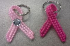 two knitted keychains one pink and the other light pink