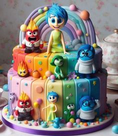 a birthday cake decorated with cartoon characters on it